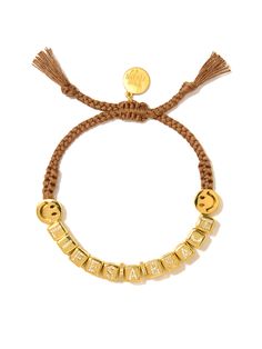 Ride the waves with a smile wearing our Life's a Beach Bracelet. With charming smiley symbols and sparkling pave rhinestones on brown threadwork, this bracelet will bring a touch of playful positivity to any outfit. 6" Adjustable brown threadwork Drawstring closure (extendable up to 8") Gold plated brass hardware Pave rhinestones Handmade in New York City and Puerto Rico. Due to the handmade nature of our products, some charms may vary in color and style or be replaced if unavailable. Please all Smiley Symbols, Daisy Bracelet, Beach Bracelets, Hair Rings, Brass Hardware, Men Necklace, Ring Bracelet, Bracelet Set, Necklaces Bracelets