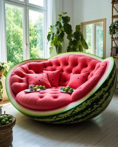 a large watermelon shaped couch sitting on top of a hard wood floor next to a potted plant