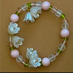 Elegant Lily Of The Valley Flower Pendant Elastic Bracelet. Beads Are Made Of High Quality Glass And Flower Pendants Are Made Of Resin. Friendship Charm Bracelets, Vine Necklaces, Fantasy Objects, Lily Bracelet, Lily Of The Valley Flowers, Valley Flowers, Indie Jewelry, Jewelry Knots, Bracelet Ideas