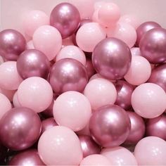 a bunch of balloons that are pink and white