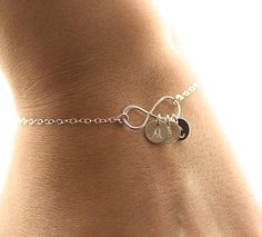 Personalized Infinity Bracelet - So sweet & delicate❤*.925 Sterling Silver or Gold Filled Components - NO plated materials*♥Dainty & shimmering flat cable chain - available in sizes from 6.25 - 8.5 inches. ♥7mm dainty discs (just over a 1/4 inch) are stamped with the initials/fonts of your choosing - please see the very last photo for font choices (uppercase script is default)!♥Dainty sterling silver infinity pendant - shiny finish. Measures 20mm - about 3/4 inch.♥Initials for this brace Silver Initial Bracelet, Initial Bracelet Silver, Infinity Anklet, Silver Infinity Bracelets, Diamond Cross Necklace Gold, Mothers Bracelet, Bracelet Initial, Infinity Pendant, Cherry Hill