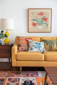 a living room filled with furniture and colorful rugs on top of a wooden floor