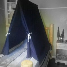 a bed with a blue tent on top of it