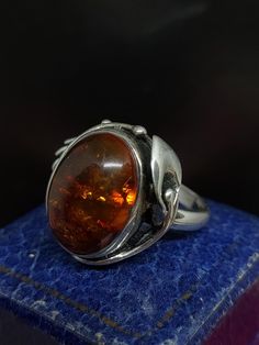 Here we have a stunning vintage statement ring with a beautiful art nouveau inspired design set with sparkling natural Baltic amber gemstone in sterling silver marked 925 UK size - P US size - 7.75 Message me any questions  ITEM - S2216 Art Nouveau Sterling Silver Rings As A Gift, Art Nouveau Sterling Silver Rings As Gift, Art Nouveau Sterling Silver Gift Rings, Antique Amber Cabochon Rings, Vintage Amber Jewelry With Polished Finish, Formal Amber Rings, Unique Amber Rings For Formal Occasions, Vintage Orange Ring Jewelry, Vintage Amber Ring Jewelry