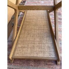 a wooden chair sitting on top of a carpeted floor next to a rug covered floor