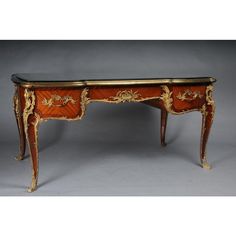 an ornately decorated desk with gold trimmings on the top and bottom edge