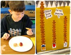 a boy eating food at a table next to a bulletin board