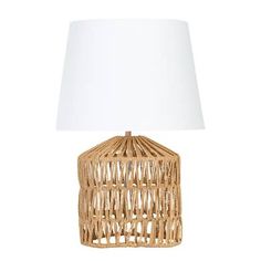 a wicker lamp with a white shade on the base and a light bulb attached to it