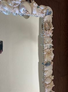 a mirror that has shells and seashells on it