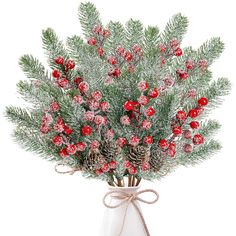 a white vase filled with red berries and pine cones