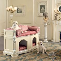 two dogs sitting on top of a white dog bed in a living room next to a fireplace