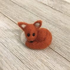 a small stuffed animal laying on top of a wooden floor