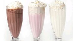 three glasses filled with different types of milkshakes