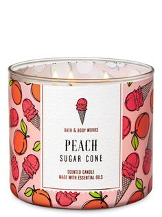 peach sugar cone candle with essential oils in a pink tin on a white background, surrounded by oranges and ice cream