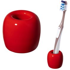 a red toothbrush holder next to a white toothbrush