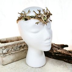 A royal summer solstice crown for men or women. Earthy green crystals on a golden Celtic weave base highlight this royal edition of our popular woodland stag circlet, inspired by the forests of Ireland and Scotland The back of this piece is open, designed to be tied together with ribbon leather, etc or just simply pinned here and there. This allows it to work well with many different hairstyles and updos. Our wire is nickel free and has a non-tarnish coat that keeps it shiny and makes it easy to Green Royal Clothes Men, Elf Crown Male, Golden Circlet Crown, Mythical Outfits, Stag Crown, Earth Crown, Warrior Crown, Crowns For Men, Forest Crown