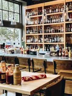 an empty bar with lots of bottles on the shelves