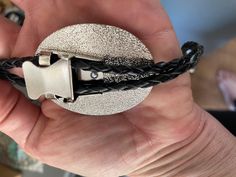 This awesome bolo tie has a vintage cowboy print with a clear resin coating and metal backing. Handmade in our shop! The cord is black and genuine leather. Our bolos pair nicely with many of our belt buckles! They make wonderful gifts. The western bolo tie rope length is 39' ; pendant size is 1 1/2'' x 1 1/4'' Black Concho Jewelry For Rodeo, Western Black Bolo Tie With Adjustable Length, Black Western Bolo Tie With Adjustable Length, Black Western Bolo Tie With Concho, Western Style Black Bolo Tie With Adjustable Length, Black Adjustable Bolo Ties For Rodeo, Adjustable Black Bolo Ties For Rodeo, Black Adjustable Bolo Tie, Adjustable Black Bolo Tie