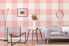 a living room with pink and white checkered wallpaper on the walls, two chairs and a table