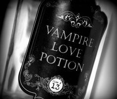 a bottle of vampire love potion sitting on top of a table next to a wall