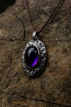 Introducing a unique handcrafted pendant that evokes the essence of a lost archaic era, this raw silver amethyst piece brings an earthy, rustic charm with a distinct medieval inspiration. The organic, textured silver frame encircles a captivating deep violet amethyst, reminiscent of a relic unearthed from ancient times. Each detail reflects the dedication to capturing the beauty of imperfection, allowing the natural elements to speak for themselves. The silver's raw finish gives the pendant an a Dark Amethyst, Protection Amulet, Raw Beauty, Spiritual Connection, Amethyst Gemstone, Silver Frame, Crystal Items, Rustic Charm, Timeless Pieces