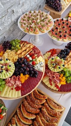 a table topped with lots of different types of food and desserts next to each other