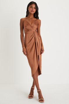 Grab their attention in the most glamorous way with the Lulus Fabulous Affair Bronze Satin Surplice Tulip Midi Dress! Sleek and elegant woven satin shapes this dress that features a sleeveless bodice, a surplice neckline, and adjustable spaghetti straps. A high, banded waist tops a drapey, overlapping skirt that ends at a tulip-inspired midi hem that boasts a high-low effect. Hidden back zipper/clasp. Fit: This garment fits true to size. Length: Mid-calf length. Size small measures 38.25" from a