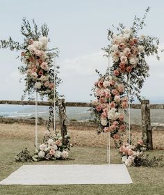 an outdoor ceremony setup with flowers and greenery