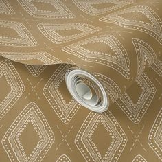 a close up view of a tan and white wallpaper with an intricate design on it