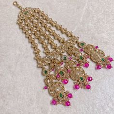 Antique gold and golden zircon jhumar with green gems and bright pink beads.  Ready to ship with Gift packaging as standard. Traditional Jeweled Tikka For Celebrations, Gold Chandbali Jeweled Tikka, Traditional Pink Kundan Necklace With Latkans, Heavy Elegant Gold Dupatta, Gold Jeweled Chandbalis In Bollywood Style, Pink Stone Work Tikka For Festive Occasions, Gold Jeweled Bollywood Tikka, Pink Stone Work Tikka For Festivals, Festive Gold Dupatta With Stone Work