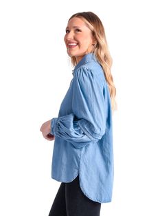 The classic Oxford shirt is our essential piece for our Core Collection. Our fun and edgy twist on a classic button-up style features a pleated balloon sleeve detail and signature gold buttons. Cotton fabric in Denim Chambray. All Emily McCarthy Clothing pieces feature a signature "Invite Joy" tag to encourage inviting joy into your life while dressing for all of life's occasions. Details: 51% Cotton 49% Spandex Slightly Tailored Fit Classic Fit with sleeve detail Fit: True to Size with slight s Casual Button-up Shirt With Blouson Sleeves, Casual Shirt With Blouson Sleeves, Casual Shirt With Blouson Sleeves For Daywear, Chic Button-up Denim Top For Fall, Chic Fall Button-up Denim Top, Fall Casual Shirt With Balloon Sleeves, Casual Fall Shirt With Balloon Sleeves, Casual Balloon Sleeve Shirt For Fall, Casual Blouse With Balloon Sleeves And Buttons