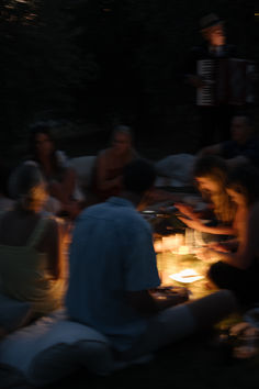 a group of people sitting around a table at night