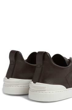 The Secondskin Triple Stitch sneaker features a glove-leather upper for mold-to-your-foot comfort and is mounted on an extralight rubber sole for a sleek look. The brand’s signature crossover elastic straps ensure an easy slip-on fit. Pull-on style with elastic laces Removable insole Leather upper and lining/rubber sole Made in Italy Designer Shoes Modern Leather Slip-on Sneakers With Vibram Sole, Leather Slip-on Sneakers With Vibram Sole And Round Toe, Functional Leather Slip-on Sneakers With Round Toe, Leather Slip-on Sneakers With Round Toe, Leather Low-top Slip-on Sneakers With Vibram Sole, Leather Slip-on Sneakers With Vibram Sole, Leather Slip-on Sneakers With Vibram Sole For Sports, Functional Leather Low-top Slip-on Sneakers, Functional Low-top Leather Slip-on Sneakers