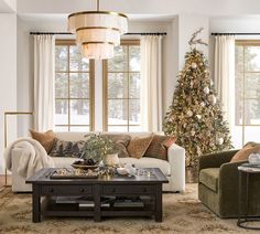 a living room filled with furniture and a christmas tree