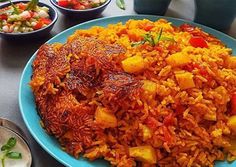 a blue plate topped with rice and vegetables