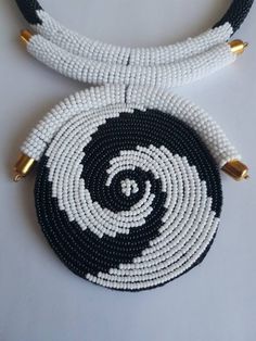 "This necklace is 100% handcrafted using white and black beads. Measurements: 18 inches around the neck. Pendant: 4\" Perfect for weddings, African themed events, traditional events etc. **Buy multiple items and pay shipping for 1 item only.The rest ships free. More neckleces here; https://www.etsy.com/shop/TribalTess?ref=seller-platform-mcnav&section_id=21306083 Back to my shop; https://www.etsy.com/shop/TribalTess?ref=seller-platform-mcnav" Unique White Jewelry With Black Beads, White Beaded Necklaces With Black Beads As Gift, White Beaded Necklaces With Black Beads For Gifts, White Beaded Necklaces With Large Beads, Handmade White Beaded Round Necklace, White Beaded Necklace With Large Beads, White Beaded Necklace With Large Round Beads, White Necklaces With Black Beads, Neck Pendant