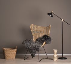 a chair, lamp and basket on the floor