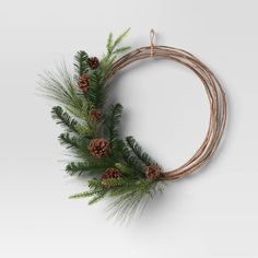 a christmas wreath with pine cones and branches