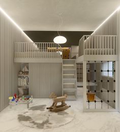 a room with white walls and stairs has a rocking horse in the center