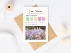 a greeting card with the words spring pastels on it next to some feathers and flowers