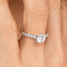 a woman's hand with a diamond ring on her finger and an engagement band