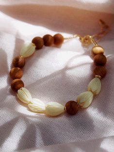 a beaded bracelet with wooden beads on a white cloth