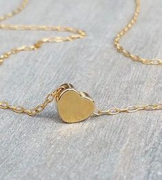 The most dainty gold necklace, such a cute tiny 14K gold-filled heart necklace.  Little goldfilled heart on a dainty 14k goldfilled chain.  Perfect with layering with other necklaces in my shop!  The necklace on the model measures 16 inches.  14k goldfilled little heart pendant measures 6 mm, so simple and sweet! You can wet the necklace and it will not tarnish - Acts like real gold  Photo #5 - Sterling Silver necklace (choose your choice from the drop-down menu)  ♥ It comes in a beautiful packa Gold Charm Necklace With Delicate Chain For Valentine's Day, Valentine's Day Gold Plated Charm Necklace With Delicate Chain, Valentine's Day Gold Charm Necklace With Delicate Chain, Dainty 14k Gold Charm Necklace With Heart Charm, 14k Gold Heart Necklace With Delicate Chain For Gift, Delicate Gold Necklace With Heart Charm, Tiny Gold Minimalist Charm Necklaces, Dainty Gold-plated Charm Necklace For Valentine's Day, Dainty Gold Plated Charm Necklace For Valentine's Day