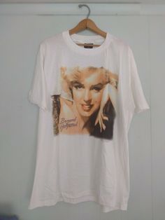 Here's an awesome, deadstock tee without tags. Dated 1993.  MEN'S XL, baggy fit 24" across chest 30" length from shoulder Save on shipping with bundles! all orders are shipped immediately. Oversized Vintage White Tops, 90s Style White Tops With Vintage Print, 90s Tops, Vintage Marilyn Monroe, Baggy Fits, Marilyn Monroe, Vintage Tees, Graphic Shirts, Bundles