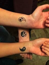 two people with matching tattoos on their arms