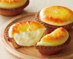 three small pastries on a wooden plate