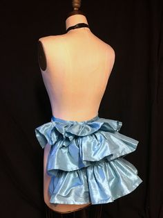 a mannequin wearing a blue dress with ruffles on it's skirt