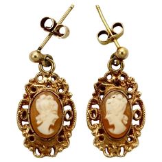 Beautiful 9K rose gold carved cameo drop earrings, with an ornate surround. The tops are yellow gold, they have butterfly backs. The backs are similar but do not match. Measuring length 2.4 cm / .94 inch by maximum width 1.2 cm / .47 inch. This is a lovely pair of ornate gold cameo earrings.