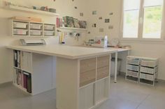 a large white kitchen with lots of drawers and counter space in front of the window