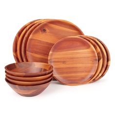 a set of wooden bowls and plates on a white background